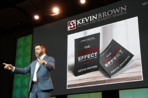 Motivational Keynote Speaker Kevin Brown on stage presenting The Hero Effect